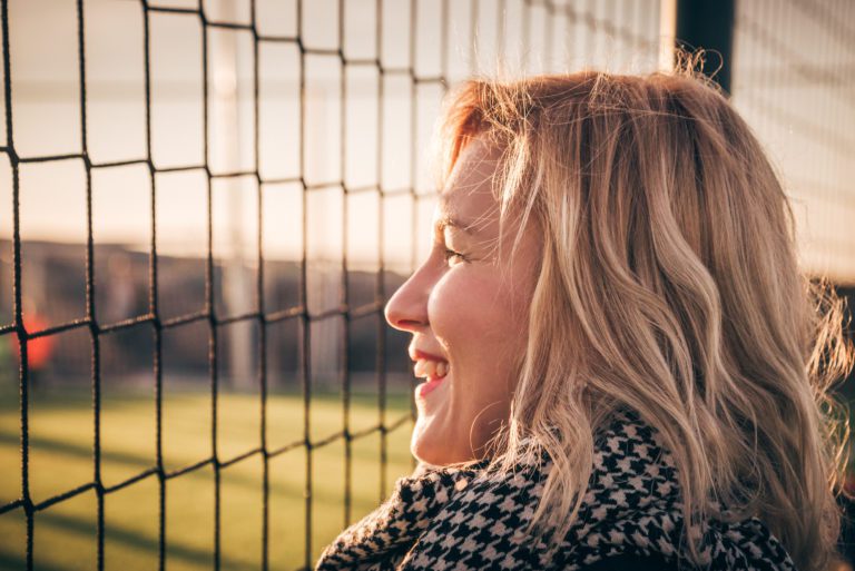 Young,Pretty,Blond,Hair,Smiling,Woman,-,Football,Fan,Portrait.