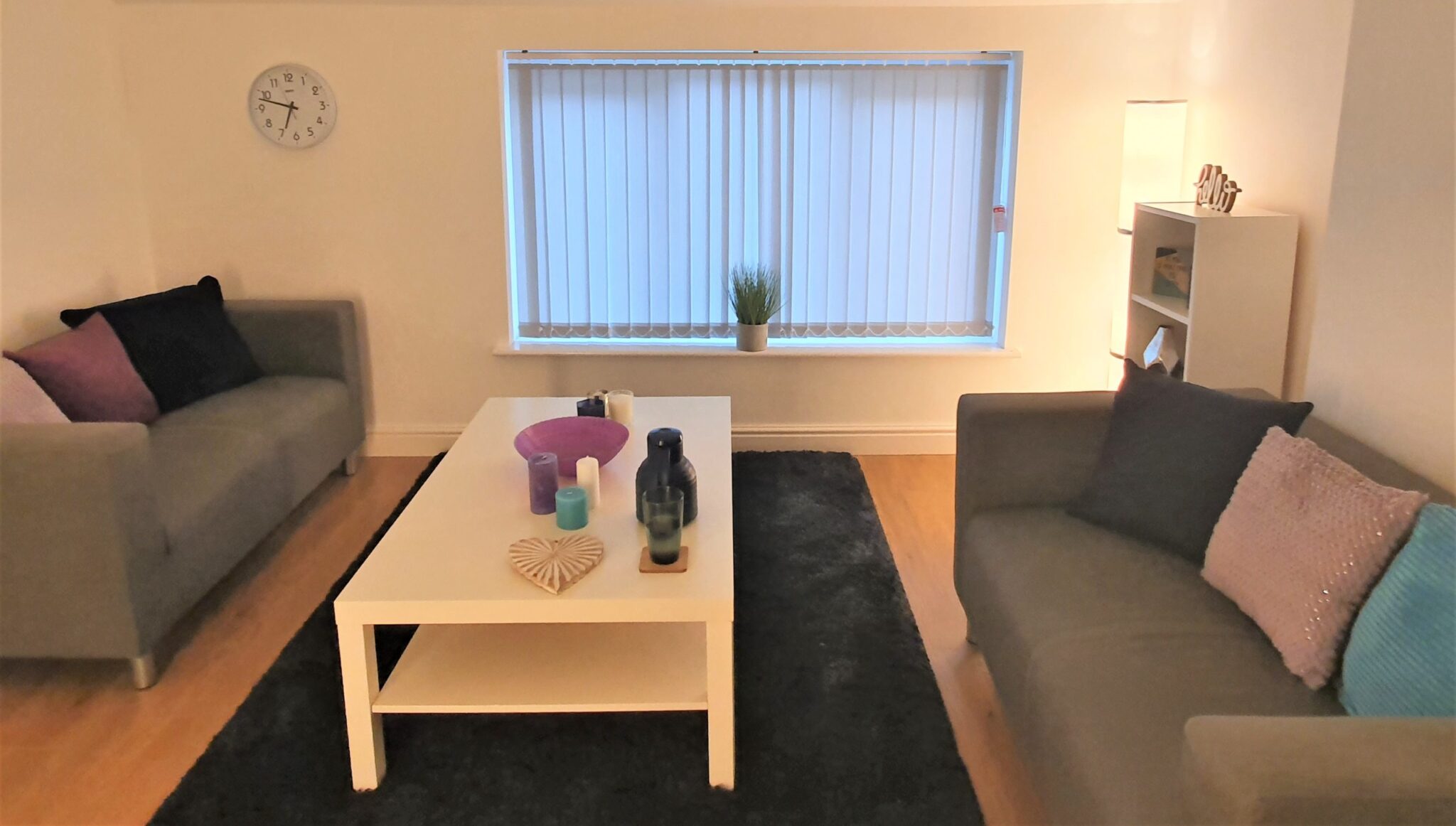 A therapy clinic with couches and a coffee table.