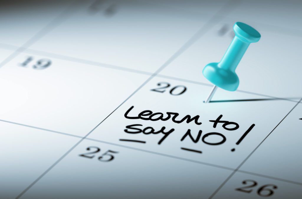 A picture of a diary, with a pin in the day that says 'learn to say no'