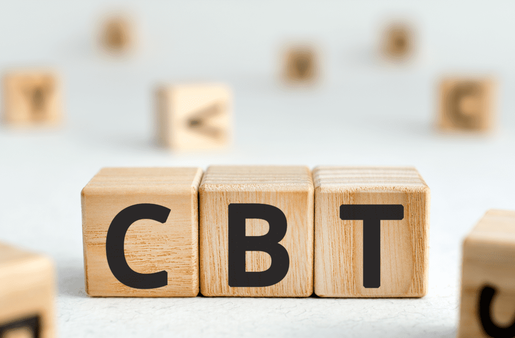 3 wooden blocks with 1 letter on each, spelling out CBT