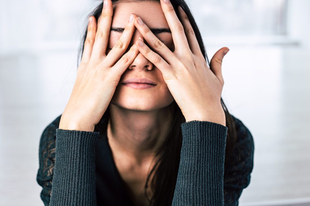 A women with her head in her hands