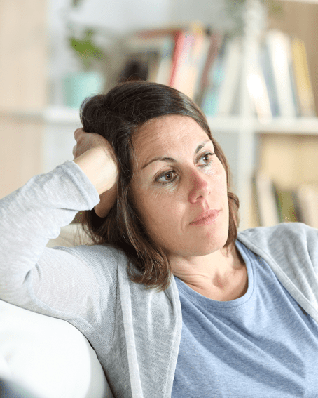 A photo of a lady looking into the distance worried