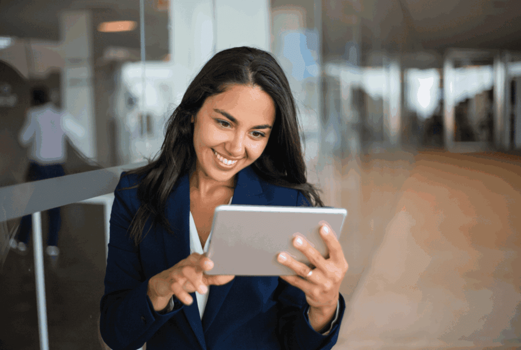 A woman in a suit using a tablet, representing professionalism and digital communication.