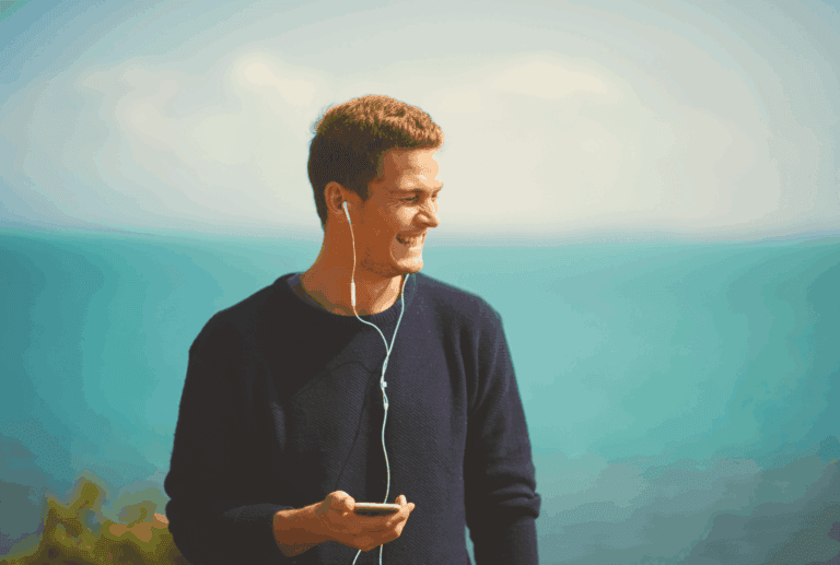 Young man enjoying music by the sea.