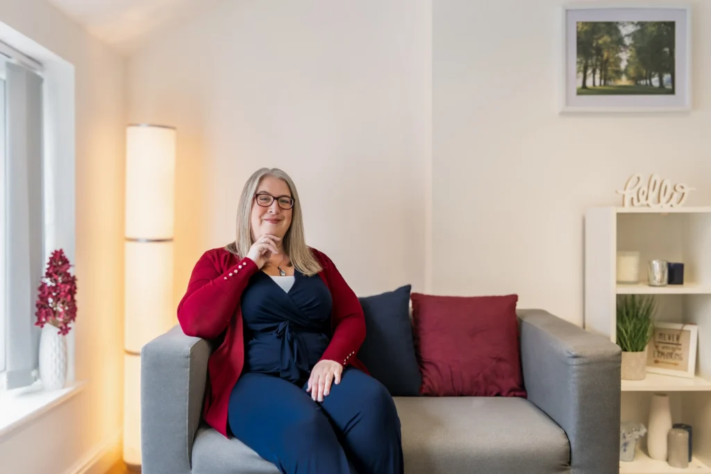 Portrait of Hannah Paskin in a modern living room with soft lighting, showcasing a stylish interior.